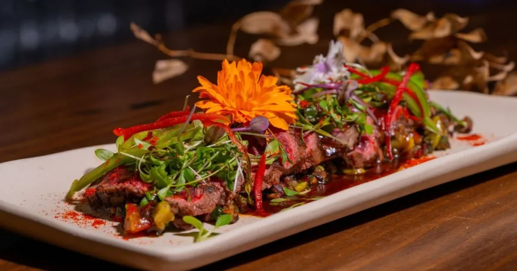 Sliced tender beef shanks garnished with fresh herbs and sauce